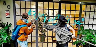 anti-gentrification protesters in Mexico City smash a window