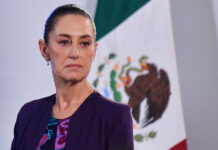Claudia versus the cartels: A perspective from our CEO Claudia Sheinbaum with a serious expression and a Mexican flag