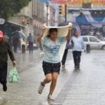 Mexico City has rainiest June in 21 years a woman gets caught in the rain in Oaxaca