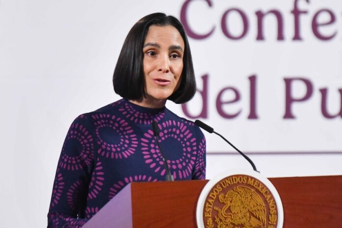 Luz Elena González speaking at podium