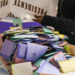 Irregularities trigger recount in troubled Veracruz elections A person dumps a box of votes onto a table