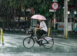 It’s official: June was the rainiest month ever recorded in Mexico A man with an umbrella rides a bicycle in the rain in Mexico City