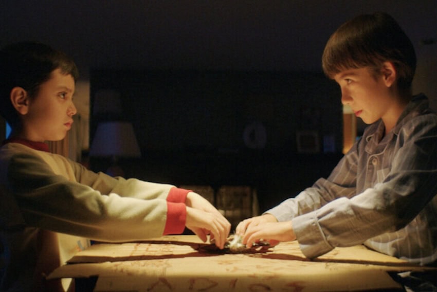 2 boys playing Ouija