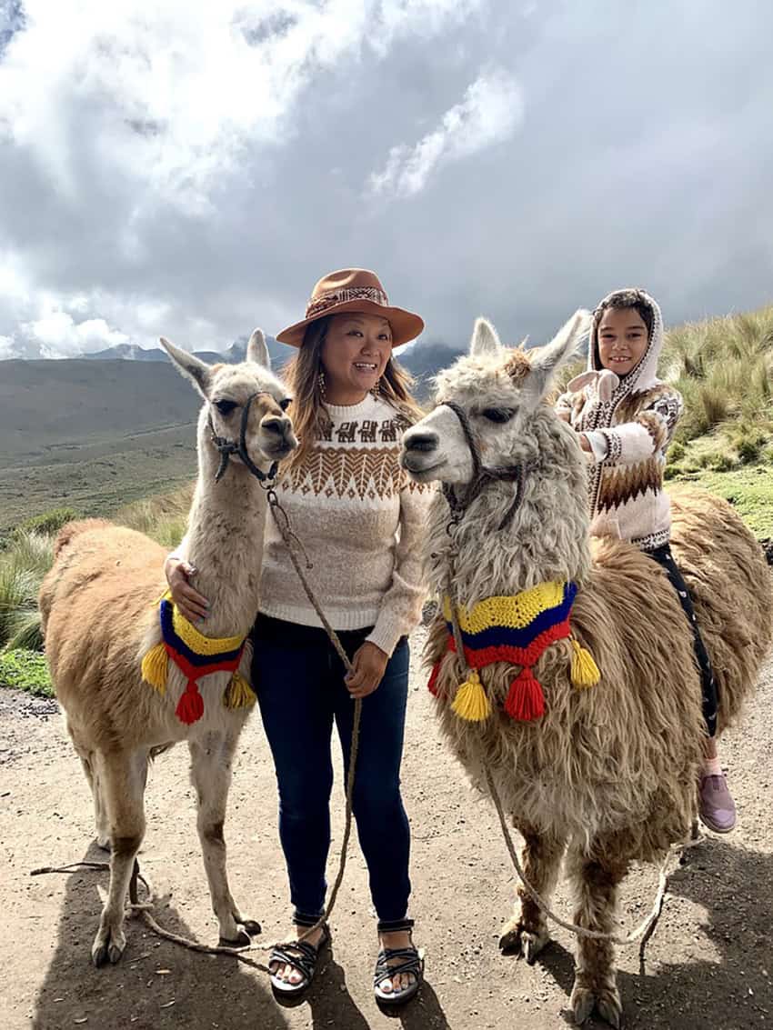 Nellie Huang and her daughter with alpacas in the Andes mountains