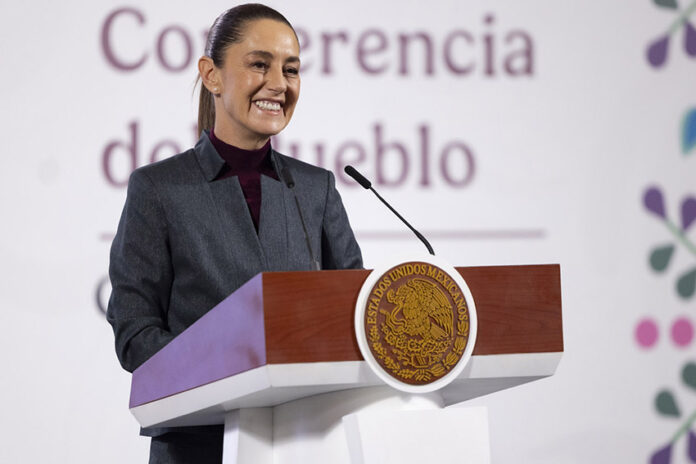 President Sheinbaum stands behind a podium at her morning press conference