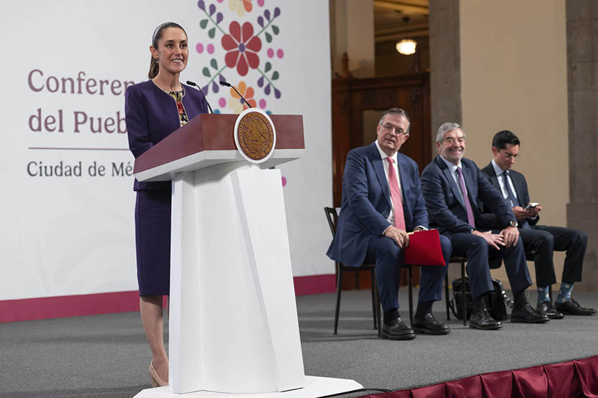 President Sheinbaum at the podium of her morning press conference with Ebrard and other officials