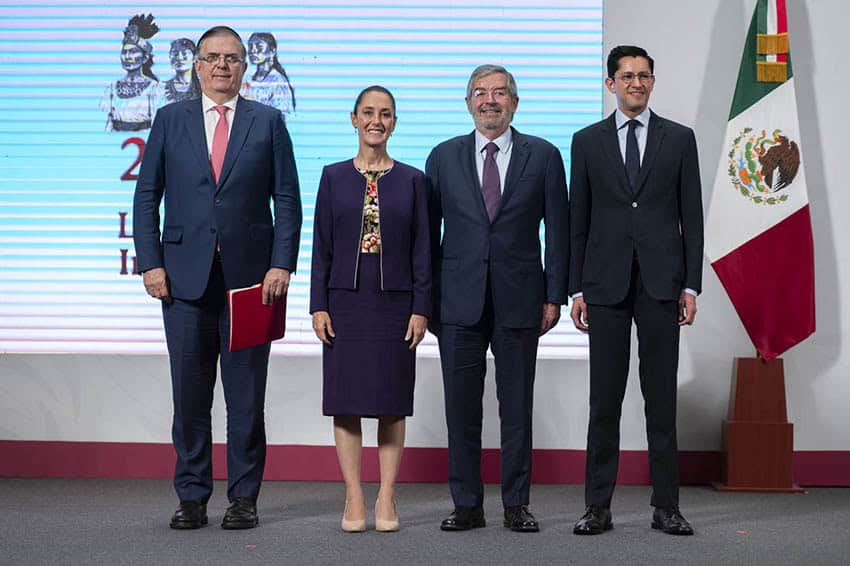 President Sheinbaum and other officials stand on stage at a press conference