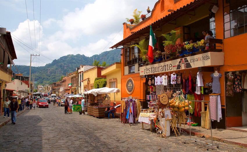 A street in Tepoztlán filled with brightly coloured buildings.