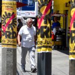 A man walks by PRD campaign posters on posts in Mexico City