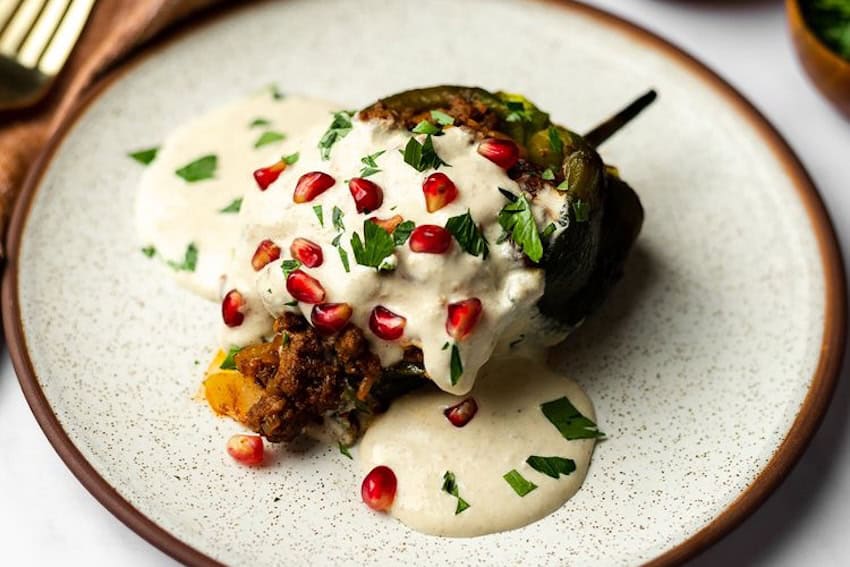 A chile en nogada served on a plate