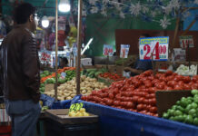 Surprise drop in inflation likely to trigger further interest rate cuts, experts predict A man looks at produce in a Mexican market