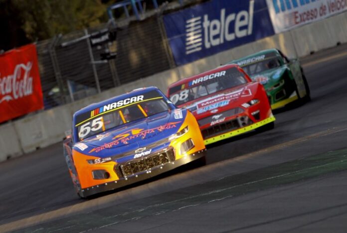 A nascar car races down a track