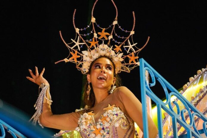 A carnival queen dances in an elaborate starfish costume