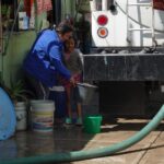 Per capita water use in Mexico City is double that of China’s capital man with hose indoors