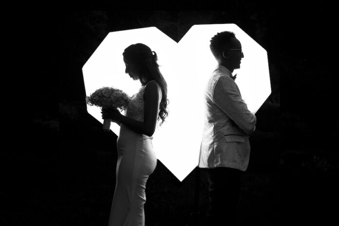 A married couple facing in opposite directions