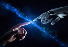 How do we make sure that AI doesn’t make us dumber? A perspective from our CEO An AI robot hand reaches out to touch a human hand