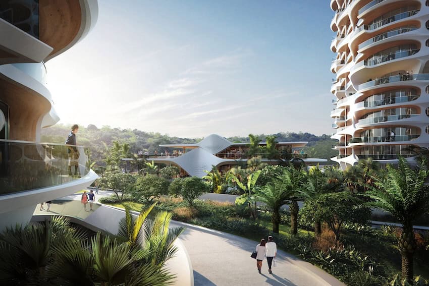 A futuristic rendering of rounded twin residential towers with large glass balconies on each floor. The towers are located on either side of a walkway where people are portrayed strolling. The jungles of Cancun lie in the photo's background.