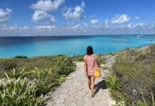 Nellie Huang walking on a cliffside path in the Riviera Maya