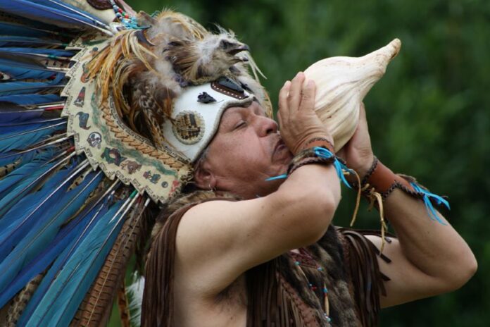 Shaman blowing conch horn