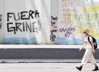 With Mexicans feeling let down by the United States, what can YOU do about it? A perspective from our CEO A blonde woman walks past graffiti reading "Fuera gringo" in Mexico City