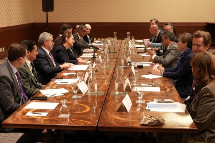 men in suits seated around a conference table at G7