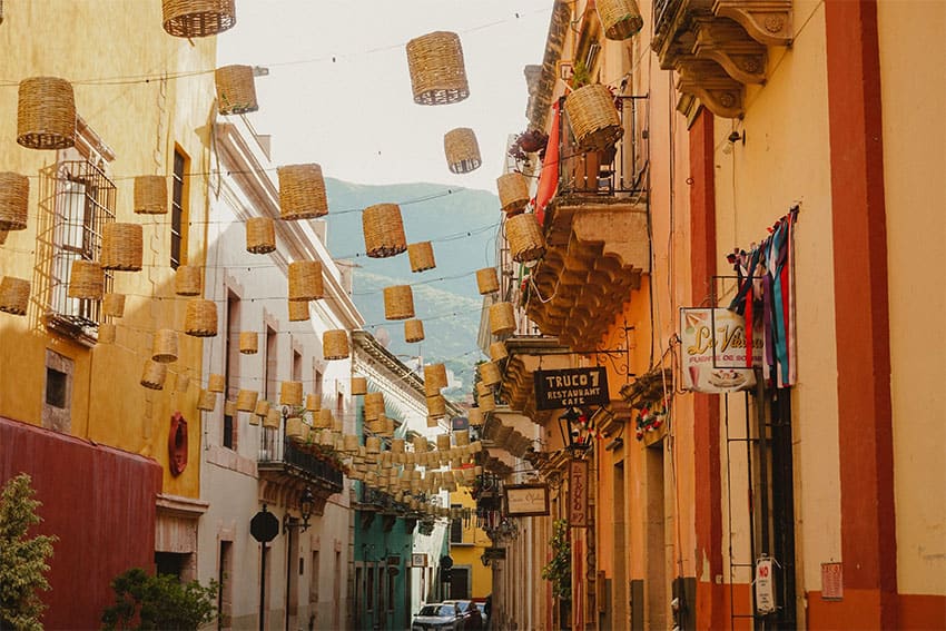 A view down a narrow, brightly painted street in Guanajuato.
