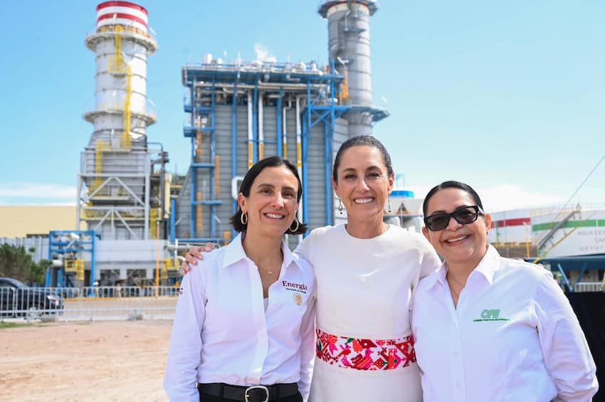 three women in front of gasworks