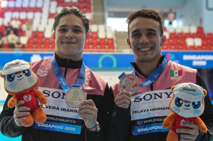 two swimmers holding medals