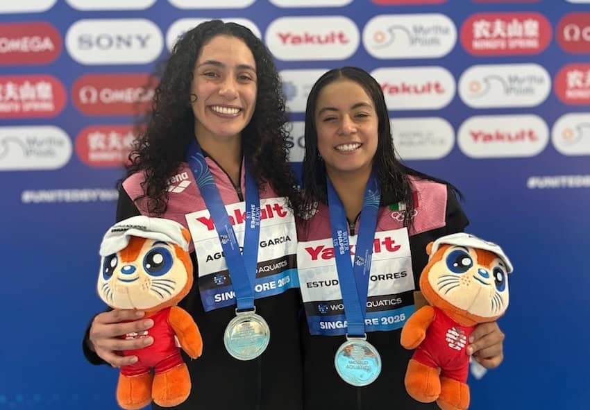two women with their swimming medals