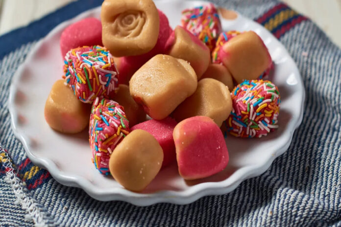pieces of caramel-colored Mexican fudge, some tinted pink and some sprinkled with multicolored sprinkles