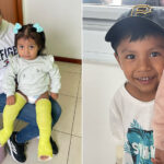 Two children, patients of Kids First Orthopaedics, smile at the camera. One little girl has casts on both legs. The other, a little boy, hides behind his mother