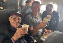Lessons on life from seat 2C: A perspective from our CEO Travis and Tamanna Bembenek raise styrofoam cups to toast with Luis, an elderly Mexican man, on a plane