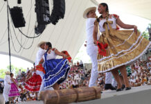 Guelaguetza kicks off in Oaxaca with performances and the festival’s first ‘Monday on the Hill’ Dancers in traditional garb including long colorful skirts dance on a stage a Guelaguetza in Oaxaca
