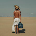 What’s on in Mexico City in August 2025? A photo of a shirtless man wearing white shorts stood on a beach