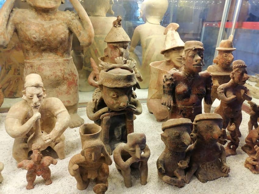 Pre Columbian figurines in glass case