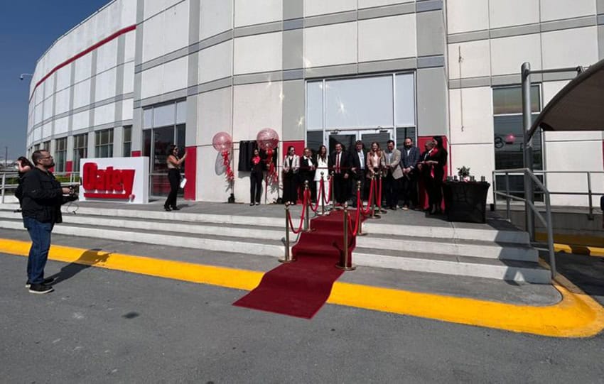 A red carpet in front of a new cement factory