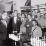 Shooting star: The story of Mexico’s first chess Grandmaster Carlos Torres standing to the left of two men in front of a chess board.