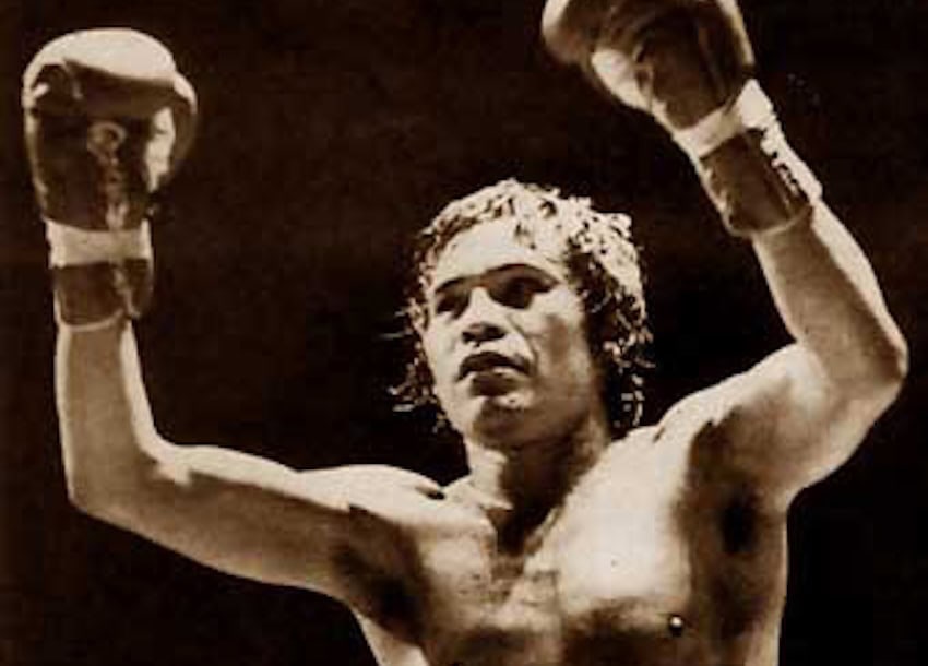 Rubén “El Púas” Olivares holding his arms in the air during a boxing match