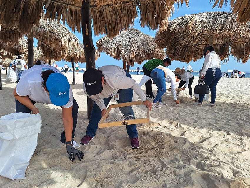 people sift sand on a beach