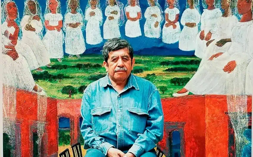 Rodolfo Morales sat in front of a large painting