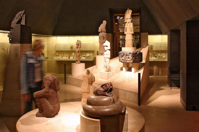 A museum room filled with sculptures and artifacts on display, all made by ancient Mexican indigenous cultures.