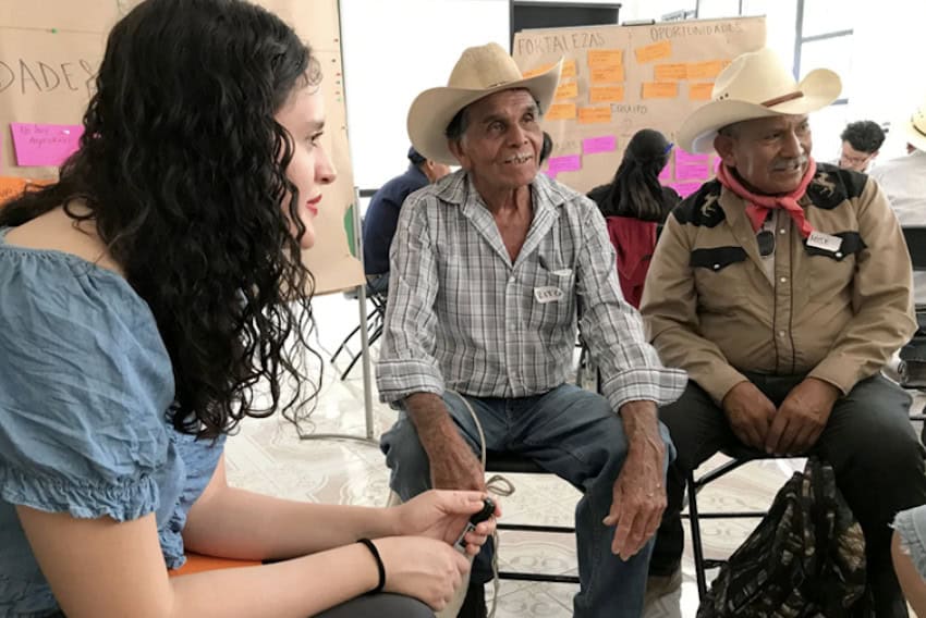 A group of people sit and talk in a circle