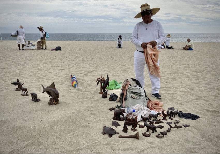 A man selling products on a beach