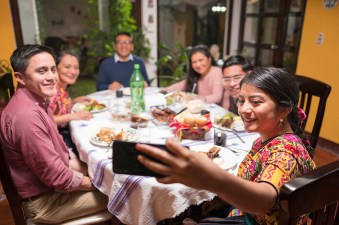 A Mexican family eats food together and enjoys a meal