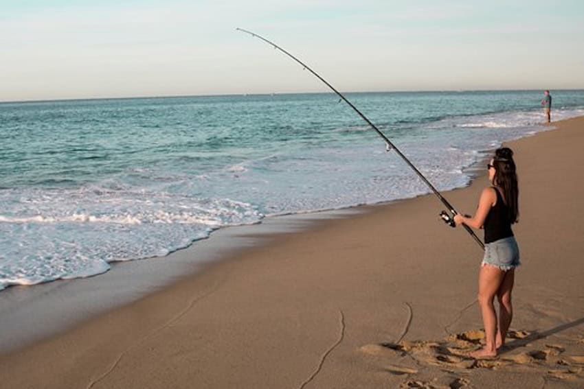 A woman fishing on the beach in Los Cabos
