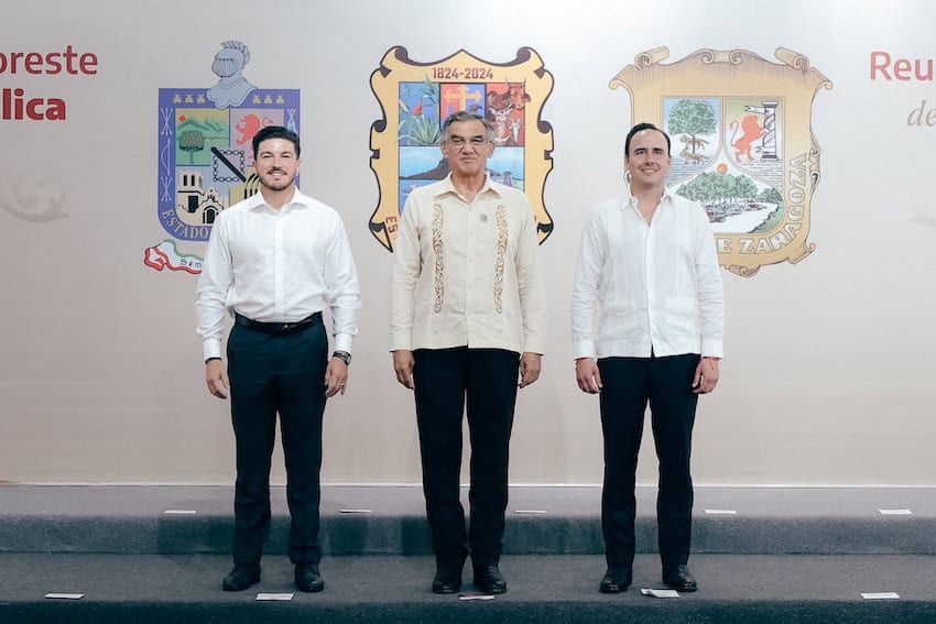 3 men standig in white shirts
