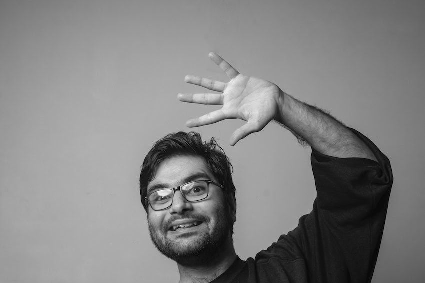 Black and white photo of a man waving