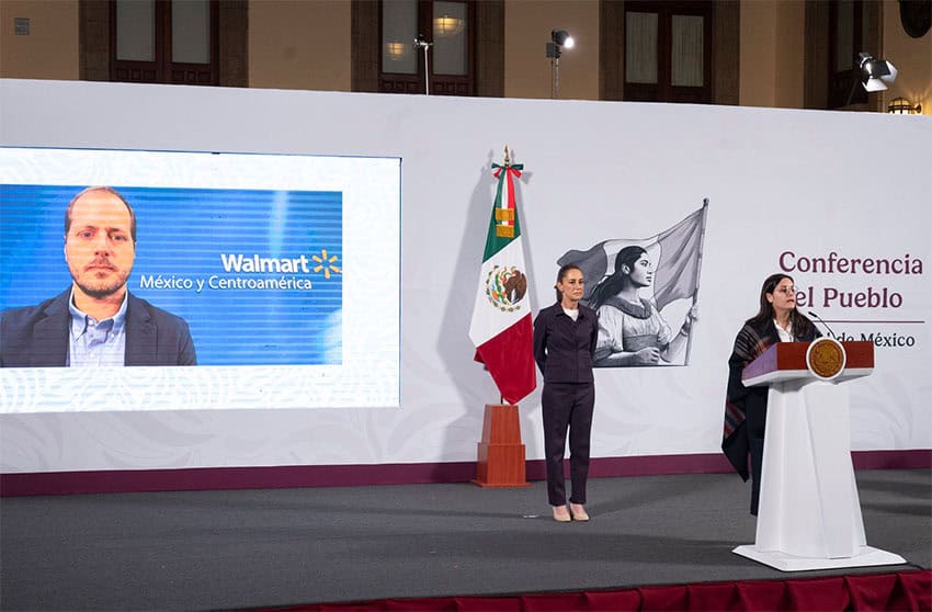 Walmart Mexico CEO Ignacio Caride appears on a screen on stage a President Claudia Sheinbaum's presidential press conference