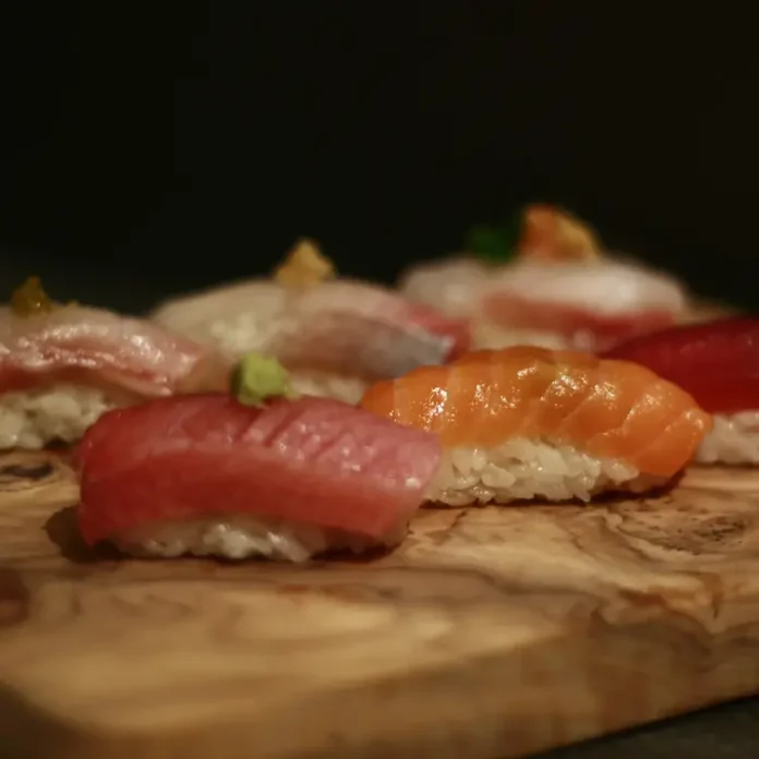 A selection of sashimi sushi on a wooden board